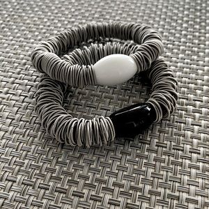 Two stretchable wire bracelets.